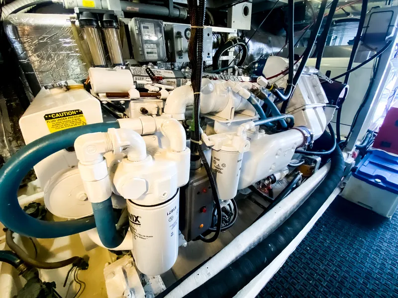 Slide: The Image of Engine room of a 1999 Navigator 5800 yacht, showcasing complex machinery and components. - 43