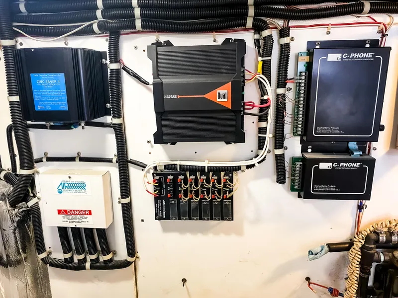 Slide: The Image of Electrical panel setup on Navigator 5800, 1999 model, featuring various control units and wiring. - 45