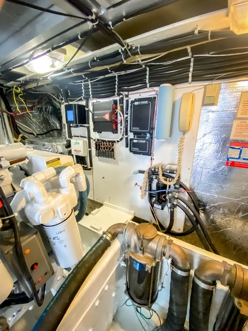 Slide: The Image of Engine room of 1999 Navigator 5800 yacht with control panels and piping. - 46