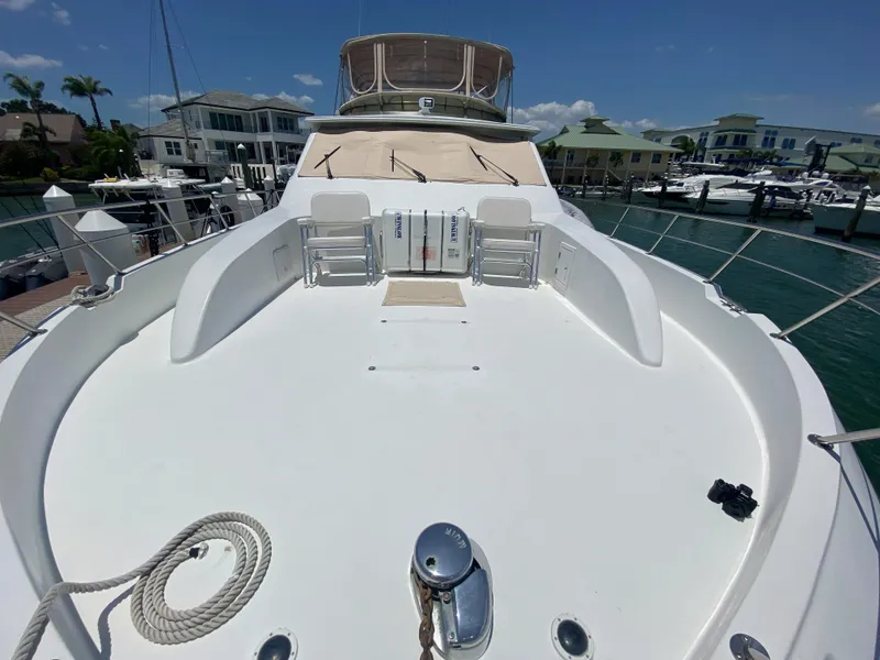 Slide: The Image of Front deck of 1999 Navigator 5800 yacht docked at marina under clear blue sky. - 5
