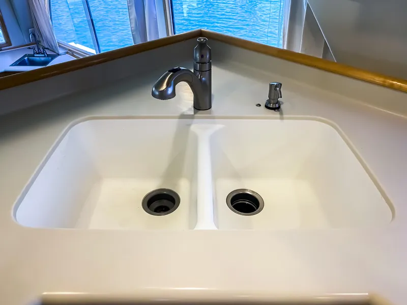 Slide: The Image of Double sink with modern faucet on Navigator 5800 yacht, 1999 model, overlooking water. - 8