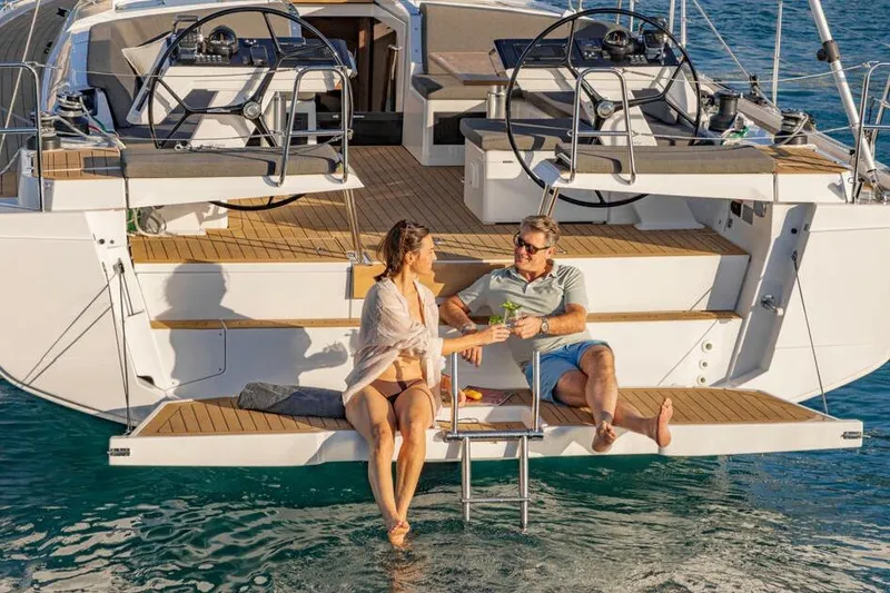 Slide: The Image of Couple relaxing on a 2025 Hanse 460 yacht, enjoying drinks by the water. - 6