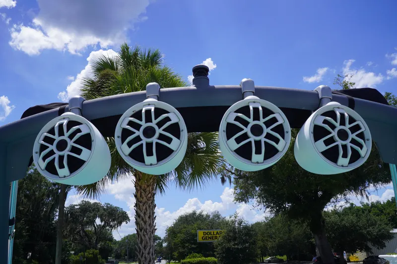 Slide: The Image of 2022 Axis A22 boat speakers against a sunny sky with palm trees. - 32