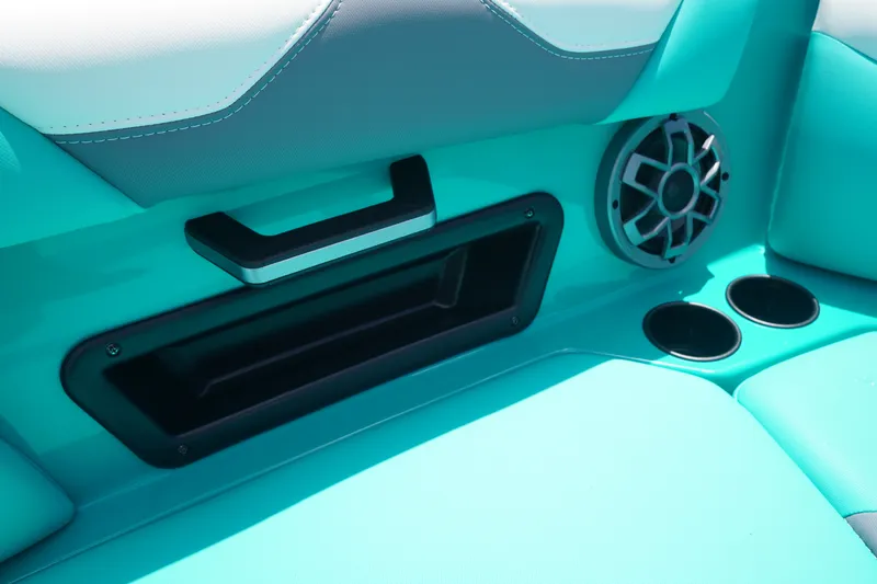 Slide: The Image of Interior of 2022 Axis A22 boat with teal seating, speaker, and cup holders. - 30