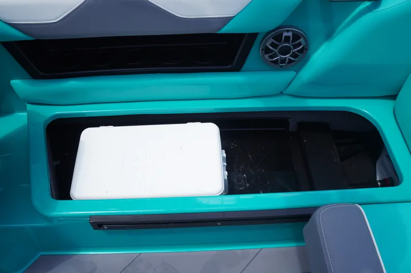 Slide: The Image of 2022 Axis A22 boat interior with built-in storage compartment and white cooler. - 20