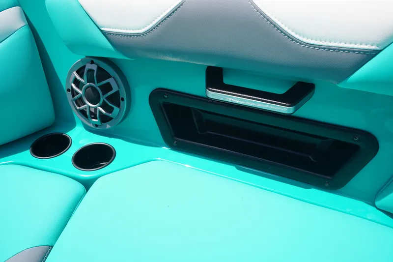 Slide: The Image of Interior of 2022 Axis A22 boat with teal seating, speaker, and cup holders. - 29
