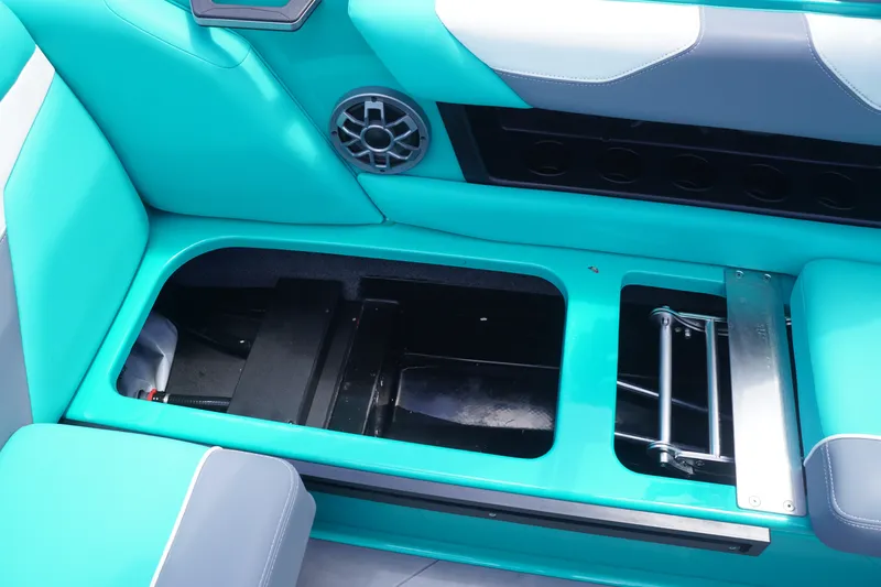 Slide: The Image of 2022 Axis A22 boat interior with teal seating and storage compartment. - 21