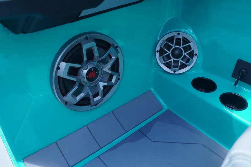 Slide: The Image of 2022 Axis A22 boat interior with teal speakers and cup holders. - 19