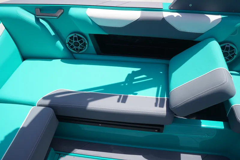 Slide: The Image of 2022 Axis A22 boat interior with teal and gray seating, featuring built-in speakers. - 14