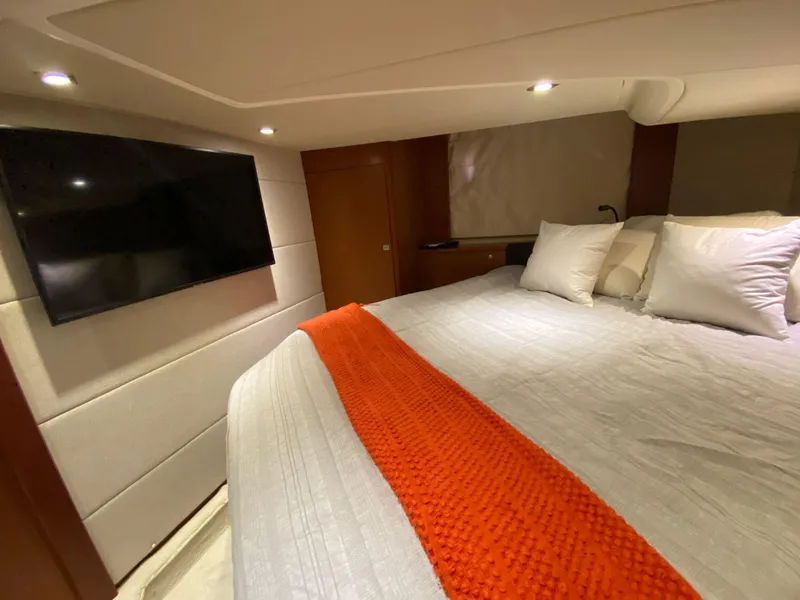 Slide: The Image of Luxurious bedroom in 2013 Prestige 440 S yacht with TV and vibrant orange throw. - 24