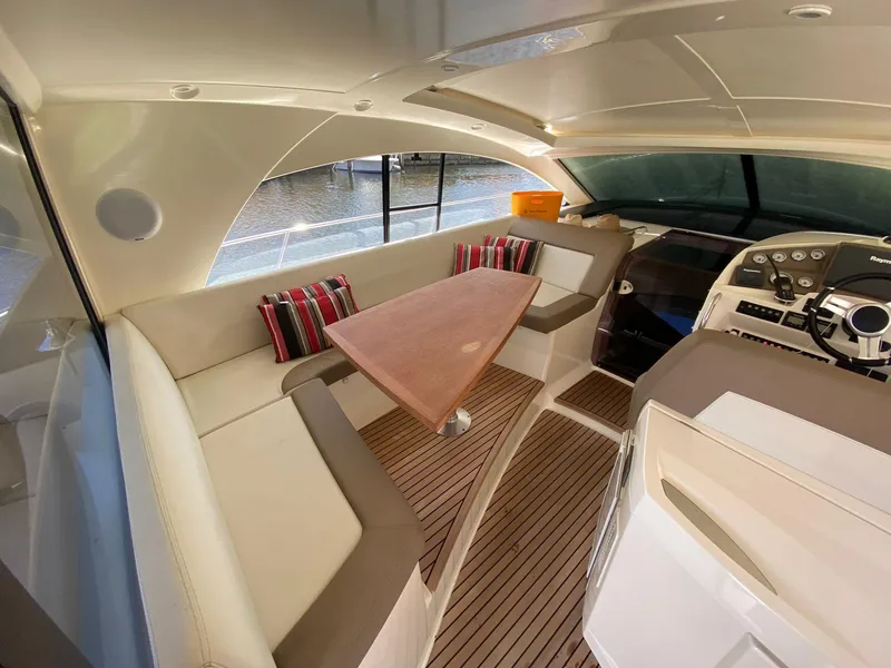 Slide: The Image of Luxurious interior of 2013 Prestige 440 S yacht with elegant seating and wooden table. - 26