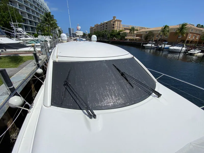 Slide: The Image of Prestige 440 S yacht docked, 2013 model, with covered windshield and wipers. - 40