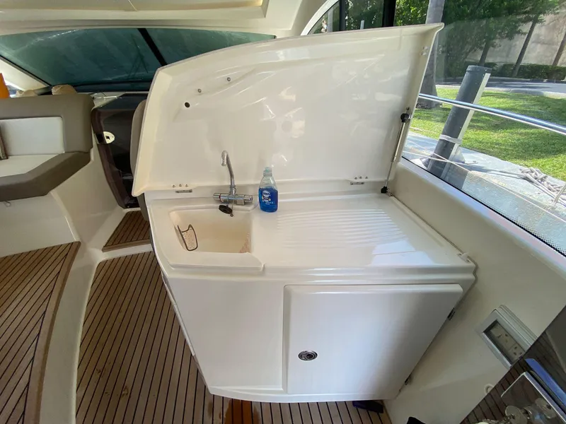 Slide: The Image of Prestige 440 S 2013 yacht interior with sink and counter on teak flooring. - 42
