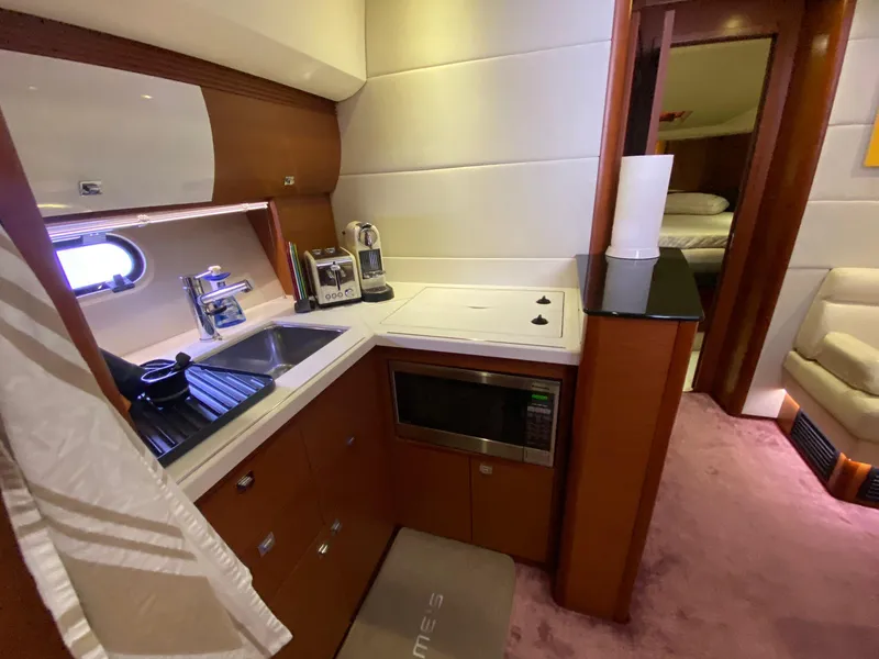 Slide: The Image of Compact kitchen in 2013 Prestige 440 S yacht with sink, stove, and microwave. - 43