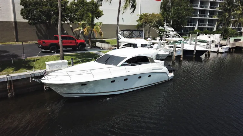 Slide: The Image of 2013 Prestige 440 S yacht docked in a marina, surrounded by palm trees. - 46