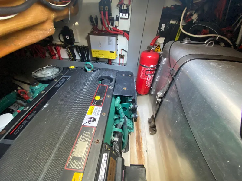 Slide: The Image of Engine room of 2013 Prestige 440 S yacht with visible machinery and fire extinguisher. - 49