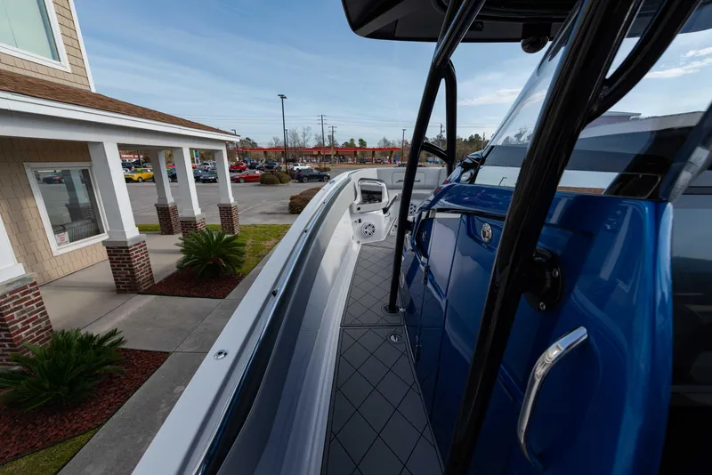 Slide: The Image of 2024 Nor-Tech 390 Center Console boat docked near a building. - 11