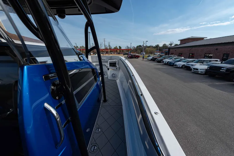 Slide: The Image of 2024 Nor-Tech 390 Center Console boat docked in a parking lot. - 12