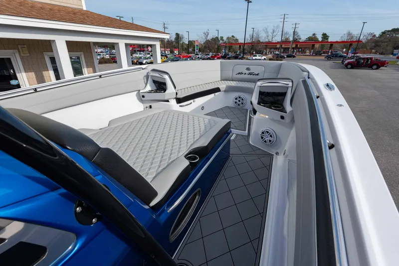 Slide: The Image of 2024 Nor-Tech 390 Center Console boat interior with cushioned seating and modern design. - 14
