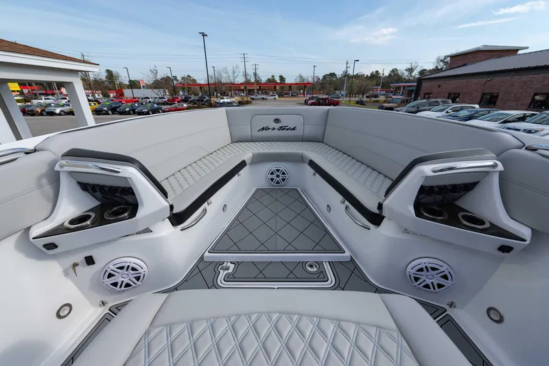 Slide: The Image of 2024 Nor-Tech 390 Center Console boat interior with seating and speakers. - 15