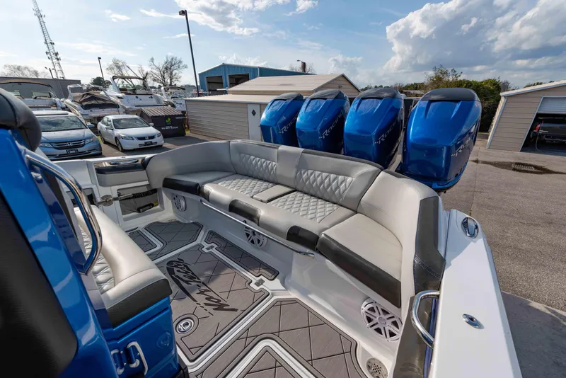 Slide: The Image of 2024 Nor-Tech 390 Center Console with quad blue outboard engines and spacious seating. - 19