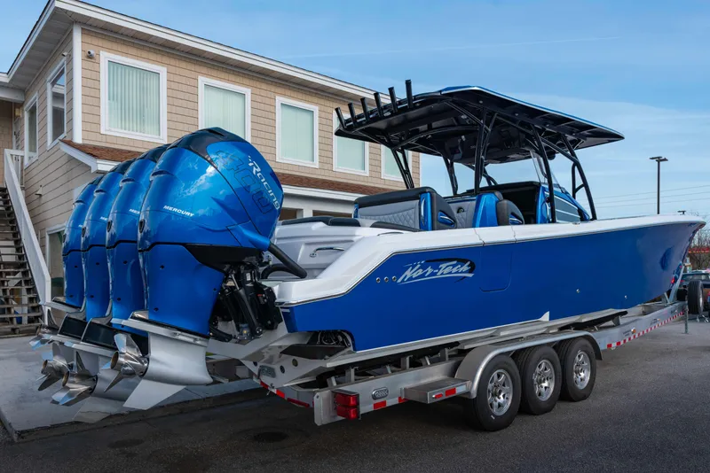 Slide: The Image of 2024 Nor-Tech 390 Center Console boat with blue exterior on a trailer. - 2