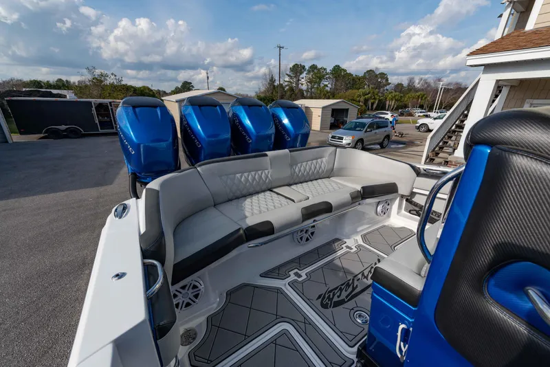 Slide: The Image of 2024 Nor-Tech 390 Center Console with quad blue outboard engines and spacious seating. - 20