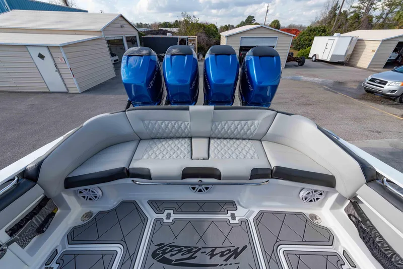 Slide: The Image of 2024 Nor-Tech 390 Center Console boat with quad blue outboard engines and spacious seating. - 21