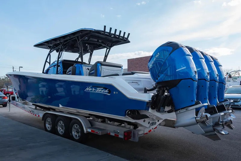 Slide: The Image of 2024 Nor-Tech 390 Center Console boat with triple outboard engines on a trailer. - 3