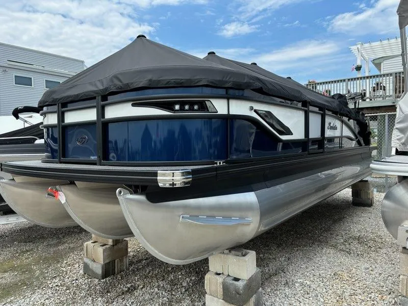 Slide: The Image of 2024 Barletta Corsa 23U pontoon boat with black cover on blocks. - 2
