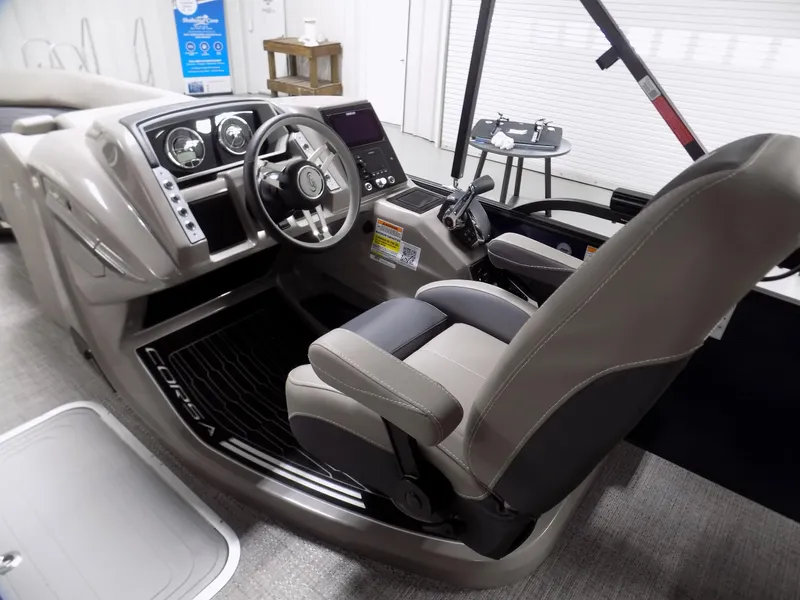 Slide: The Image of 2024 Barletta Corsa 23U boat cockpit with modern steering and controls. - 7