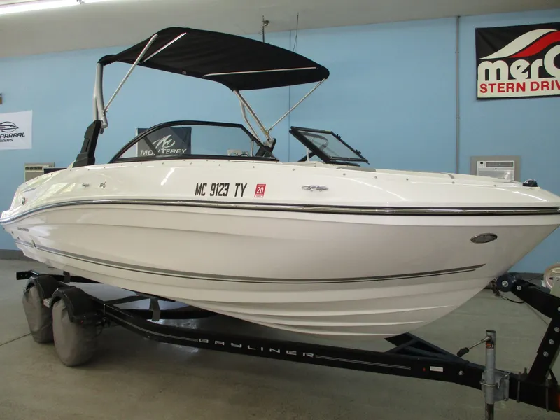 Slide: The Image of A white 2016 Bayliner VR6 Bowrider I/O on a trailer in an indoor setting. - 1