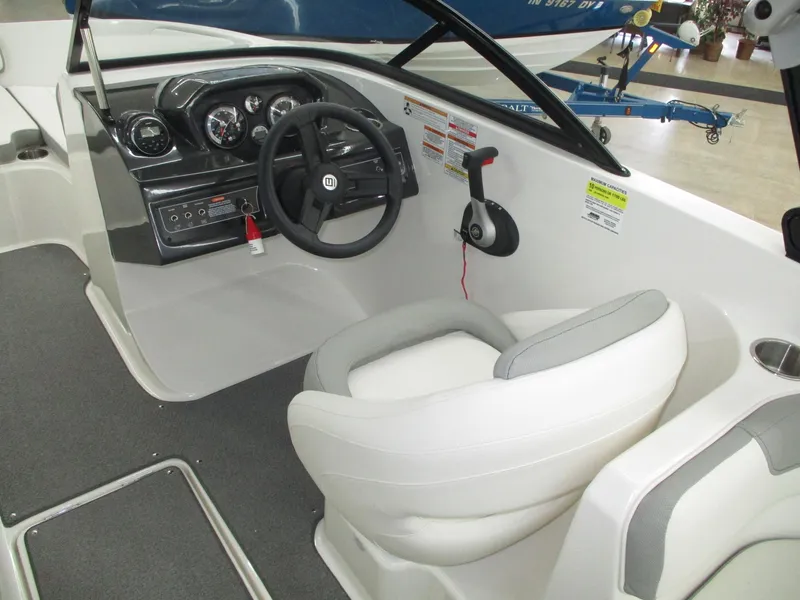 Slide: The Image of The image shows the cockpit of a 2016 Bayliner VR6 Bowrider I/O with a white seat and steering. - 7