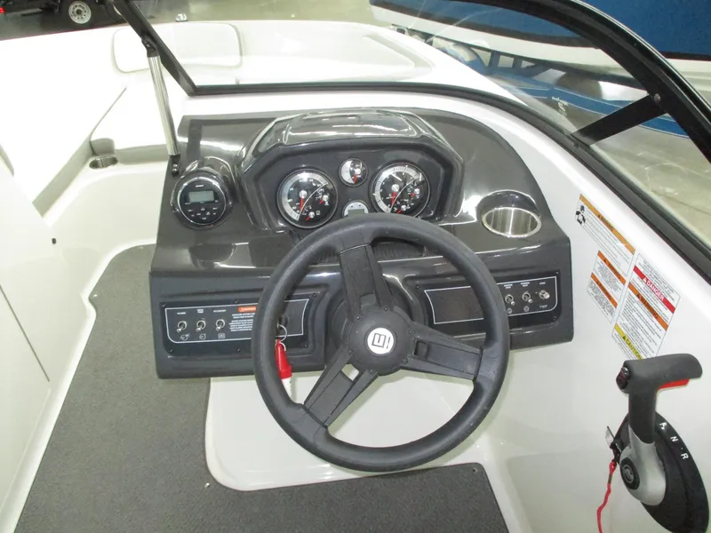 Slide: The Image of The image shows the helm of a 2016 Bayliner VR6 Bowrider I/O with steering wheel and gauges. - 11