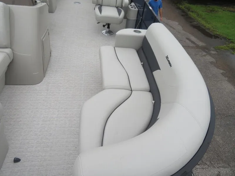 Slide: The Image of 2022 Xcursion 243RFX boat interior with plush seating and modern design. - 11