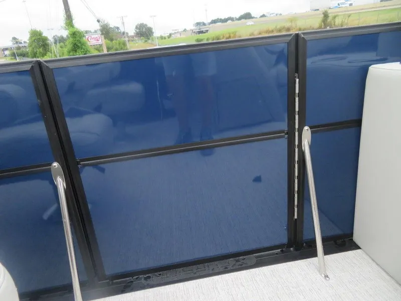 Slide: The Image of 2022 Xcursion 243RFX boat interior with blue paneling and white seating. - 12