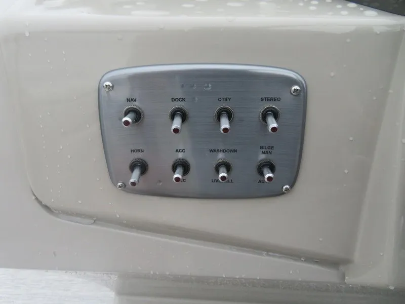 Slide: The Image of Control panel of a 2022 Xcursion 243RFX boat with various switches. - 15