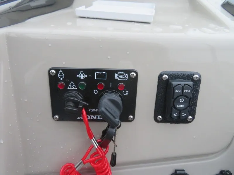 Slide: The Image of Control panel of a 2022 Xcursion 243RFX boat with Honda ignition. - 18