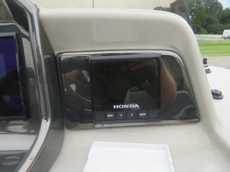 Slide: The Image of 2022 Xcursion 243RFX boat dashboard with Honda display screen. - 19