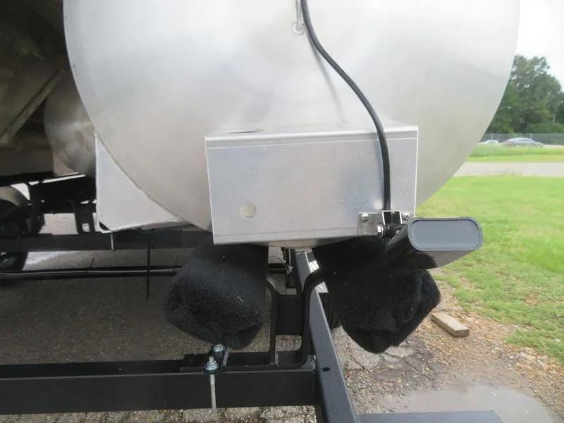 Slide: The Image of Close-up of the 2022 Xcursion 243RFX pontoon boat's underside and trailer. - 2