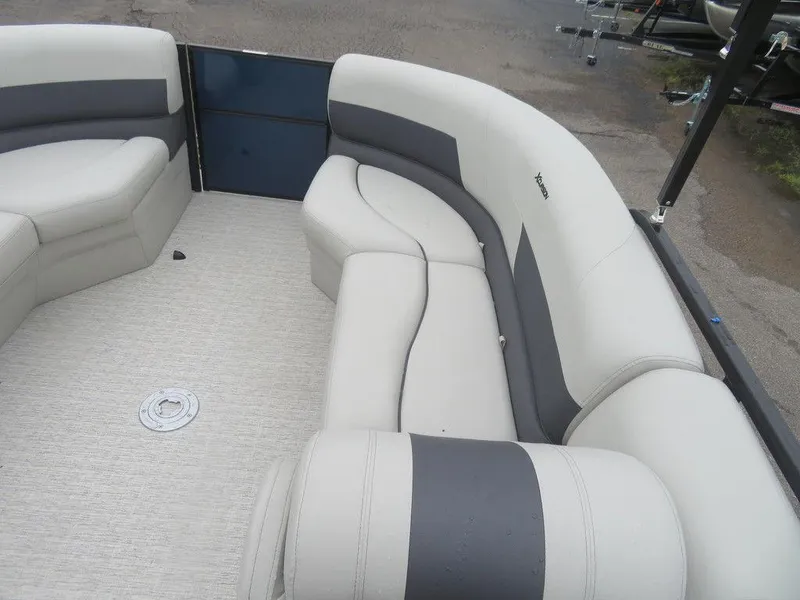 Slide: The Image of 2022 Xcursion 243RFX boat interior with gray and white seating. - 23