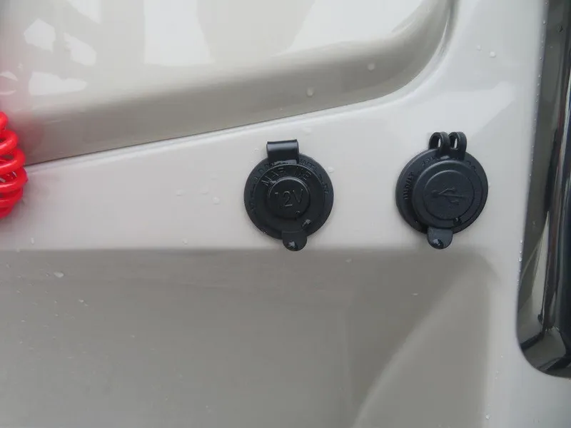 Slide: The Image of 12V and USB ports on a 2022 Xcursion 243RFX boat. - 24