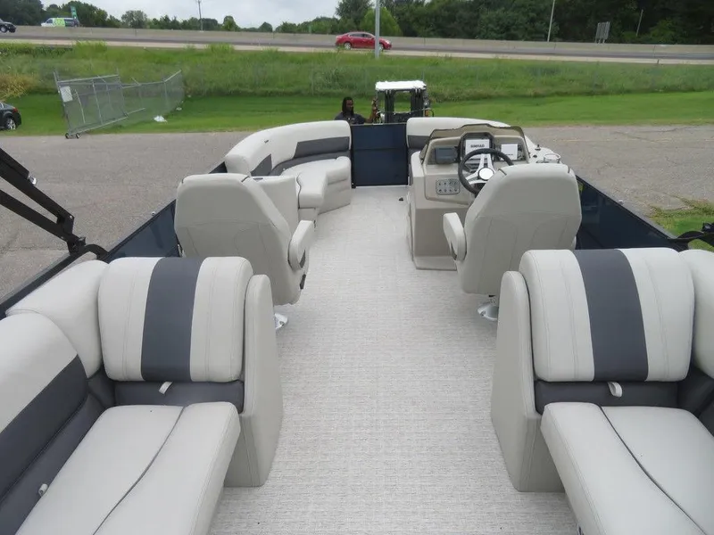 Slide: The Image of 2022 Xcursion 243RFX pontoon boat interior with plush seating and modern helm. - 26