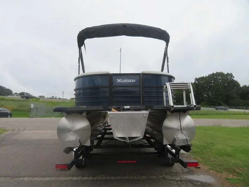 Slide: The Image of 2022 Xcursion 243RFX pontoon boat, rear view with ladder and canopy. - 3