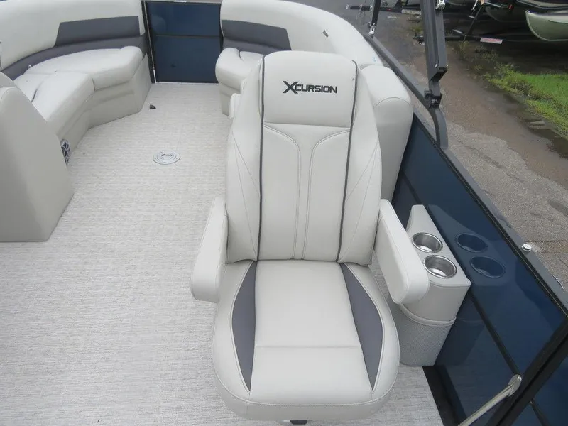 Slide: The Image of 2022 Xcursion 243RFX boat interior with plush seating and cup holders. - 7