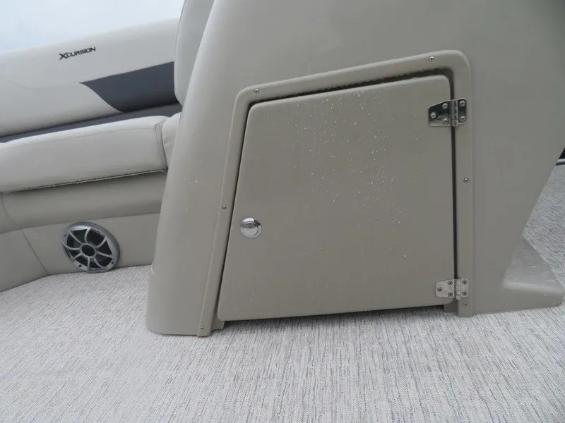 Slide: The Image of 2022 Xcursion 243RFX boat interior storage compartment and speaker. - 8