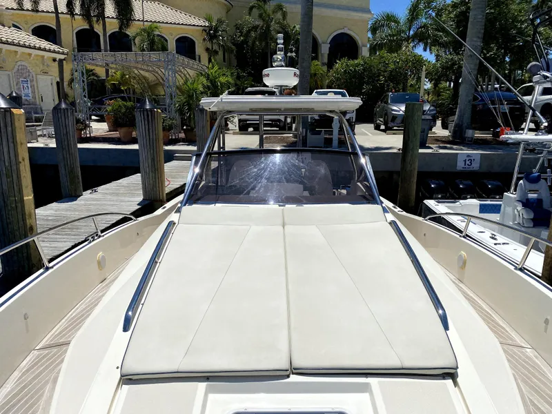 Slide: The Image of 2014 Azimut Atlantis Verve Outboard yacht docked at marina, featuring spacious sun deck. - 11