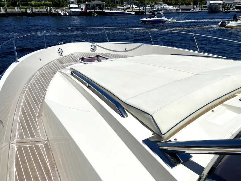 Slide: The Image of Azimut Atlantis Verve Outboard 2014 yacht deck with sunbed, docked by the water. - 15