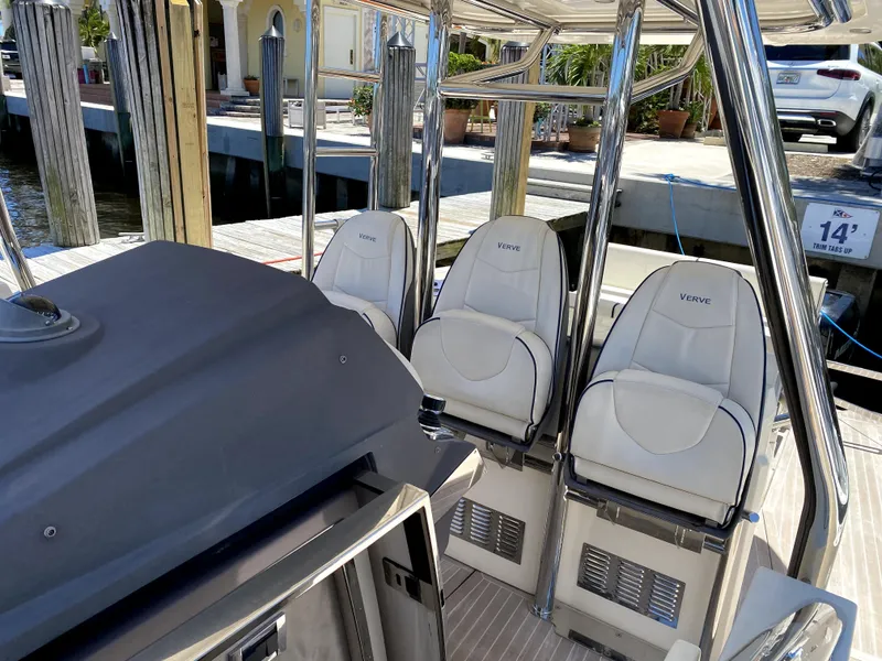 Slide: The Image of 2014 Azimut Atlantis Verve Outboard boat interior with white Verve seats at dock. - 16