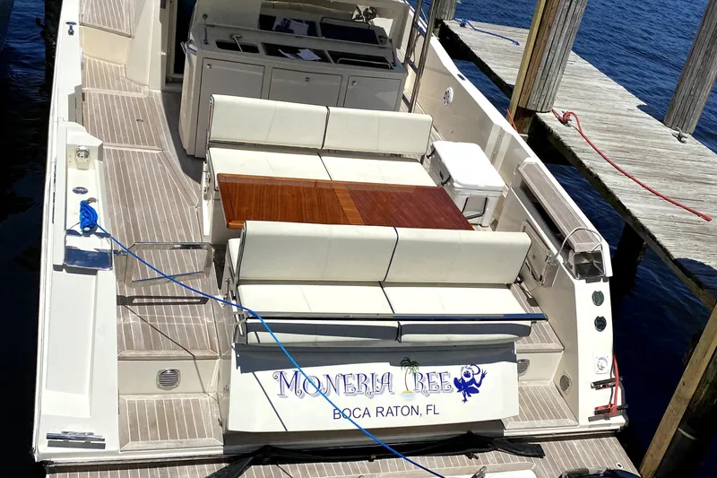 Slide: The Image of Azimut Atlantis Verve Outboard 2014 docked, featuring spacious seating and elegant design. - 2